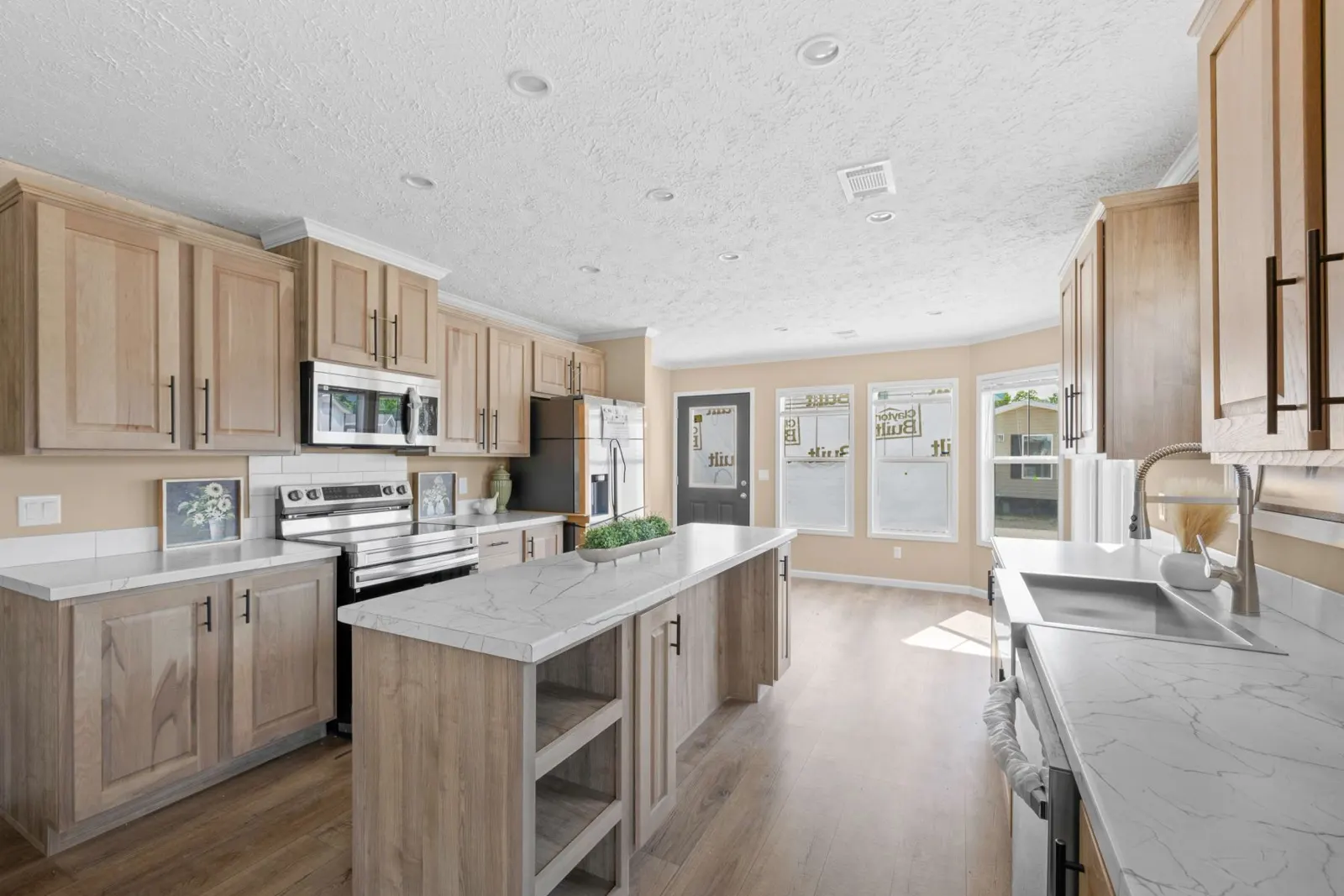 Natural wood cabinets and marble-look island