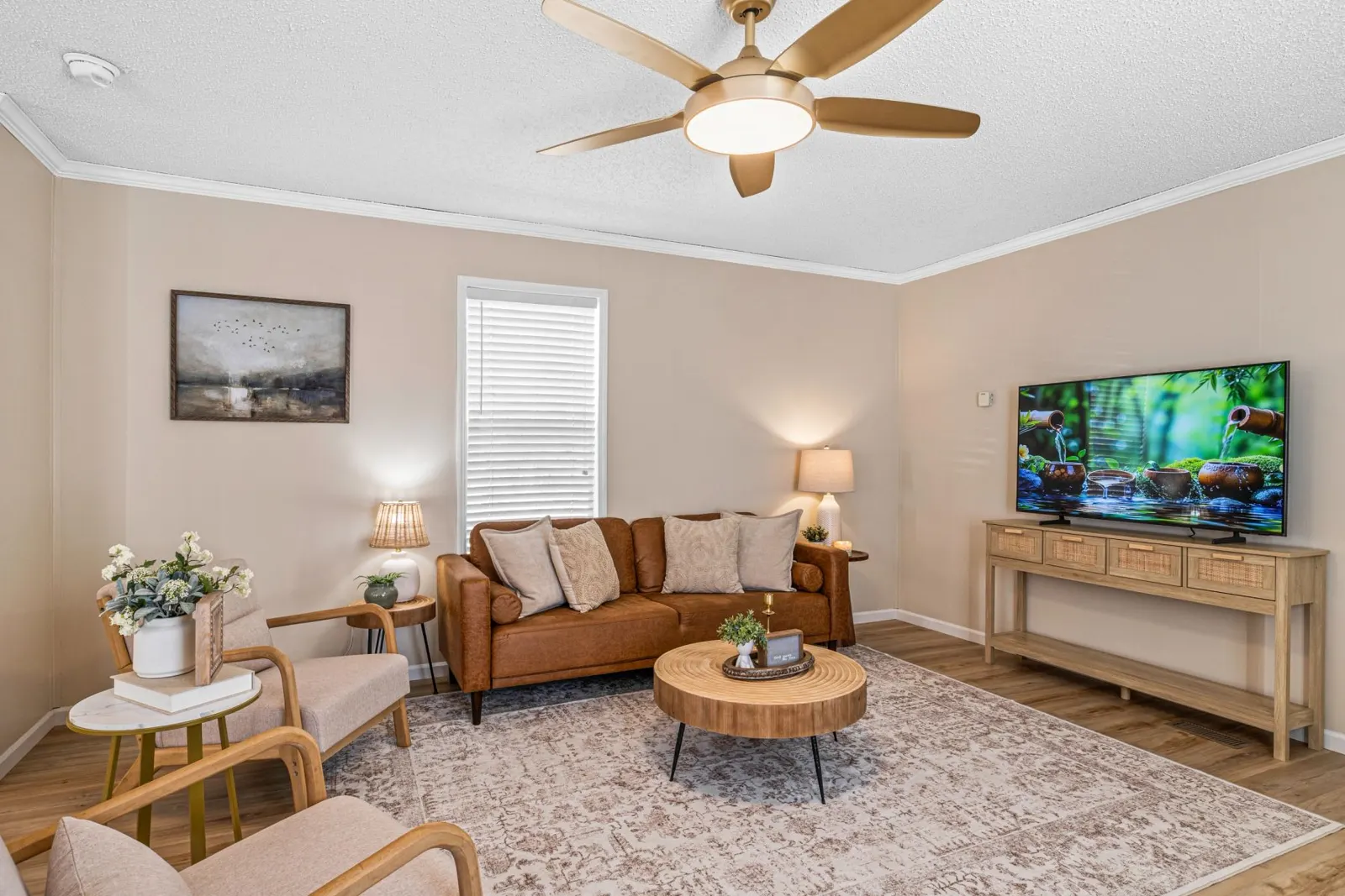 Staged living room with leather sofa, wood coffee table and warm lighting